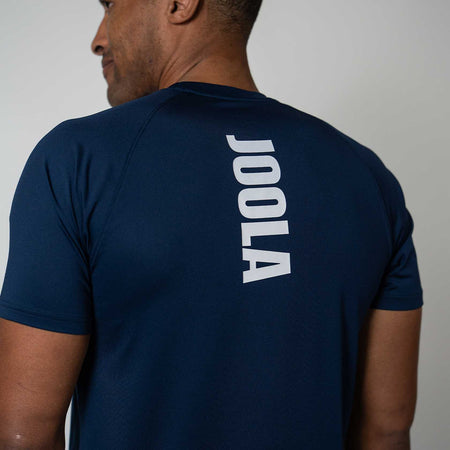 Person wearing a navy blue t-shirt with JOOLA branding on the back against a plain background
