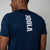 Person wearing a navy blue t-shirt with JOOLA branding on the back against a plain background