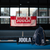 Image of a red JOOLA wordmark towel hanging over a JOOLA pickleball net.