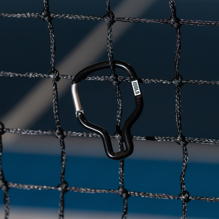 Black and white JOOLA pickleball paddle caribinar handing off a pickleball net.