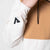 White background, close up of the JOOLA trinity logo on the sleeve of the JOOLA Half Zip.