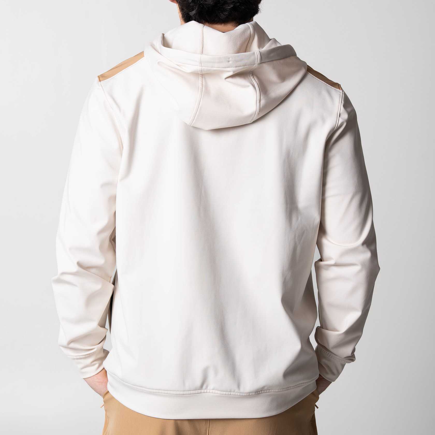 Gray background, the back of a white and latte colored JOOLA zip up hoodie.