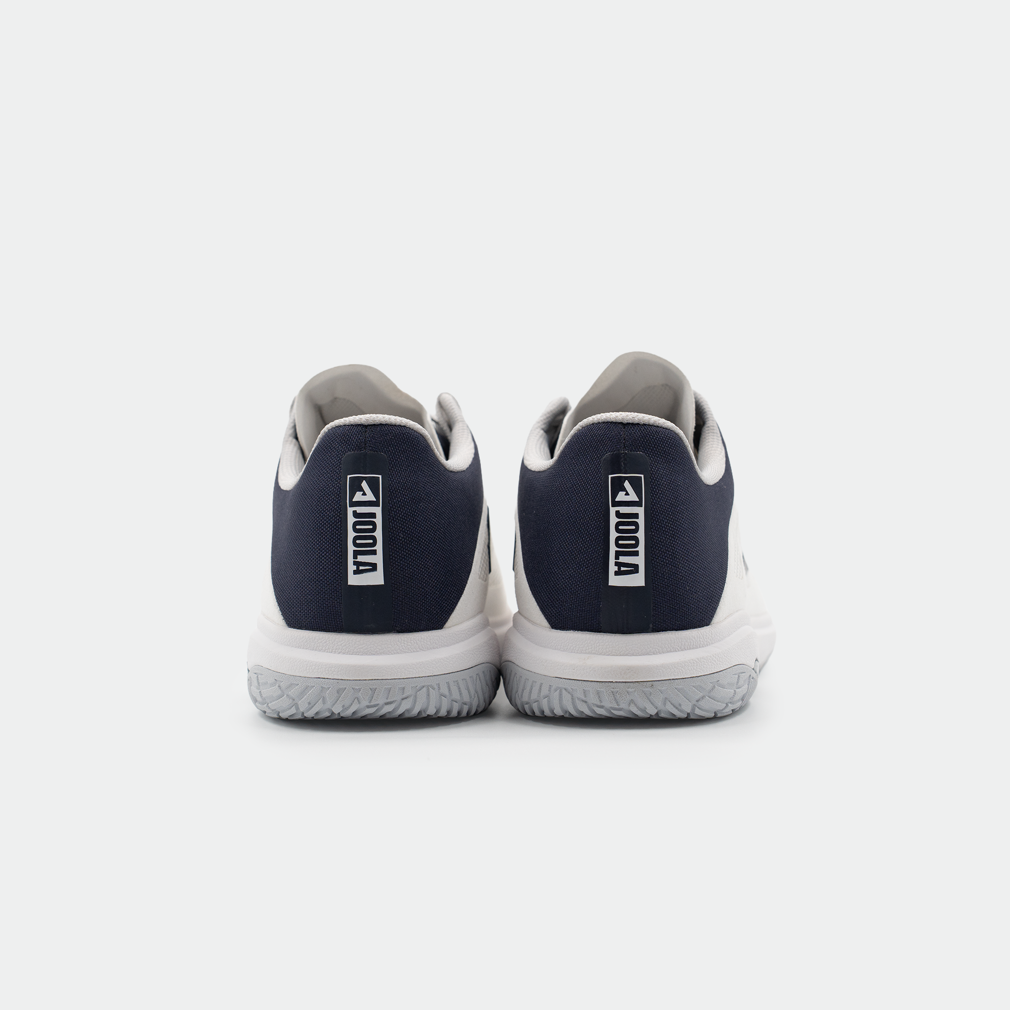 White background, product image showing the back of a pair of JOOLA TT SM4SH table tennis shoes, white and navy blue colorway.