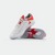 White background, product image of a pair of JOOLA TT SM4SH table tennis shoes, white and red colorway.