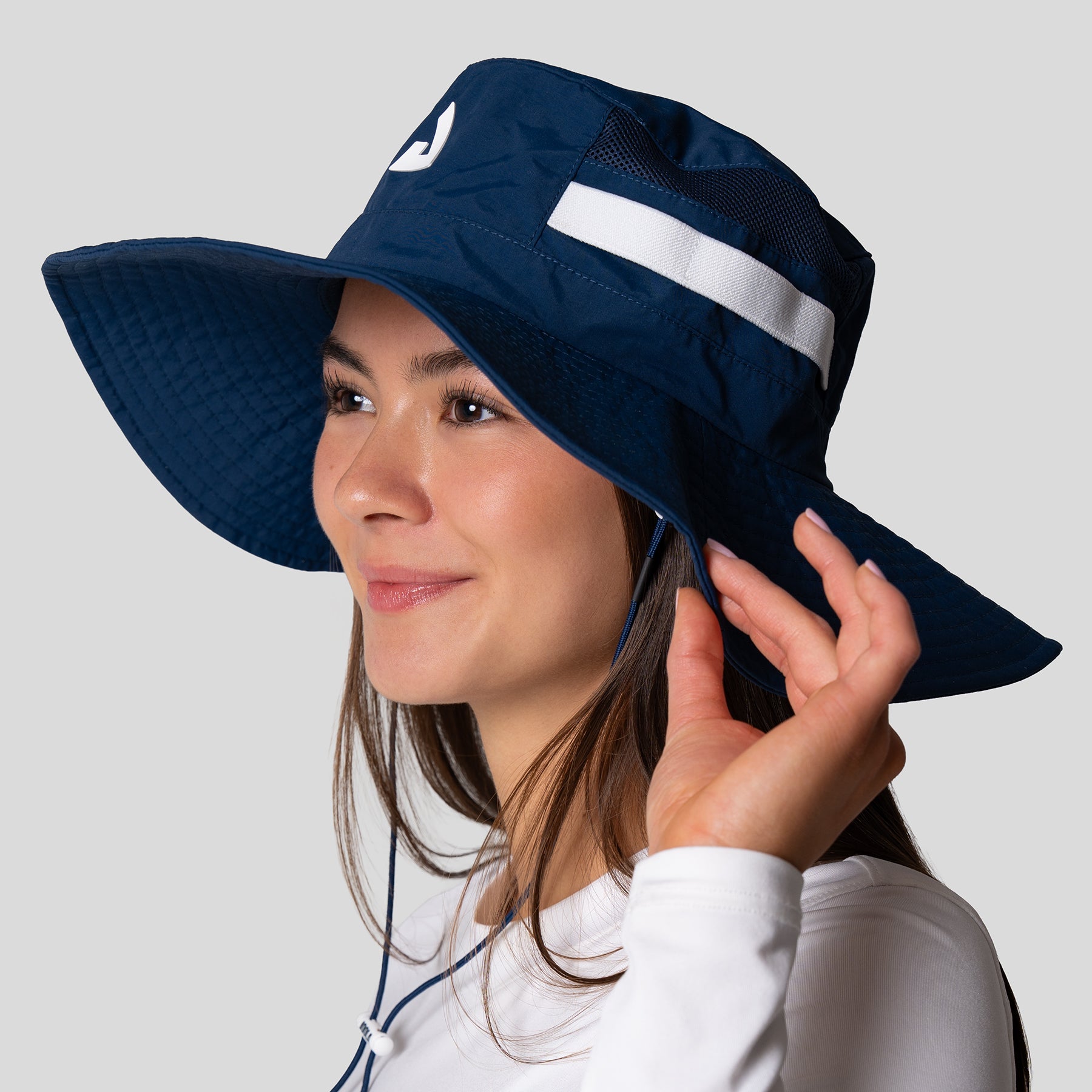 Image of a women wearing a navy blue JOOLA wide brim hat.