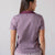 Image showing the JOOLA Trinity logo detail on the back of a JOOLA Women's Club Polo, Bordeaux heather.