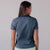 Model posing and showing the back of the JOOLA Women's Club Polo. Navy.