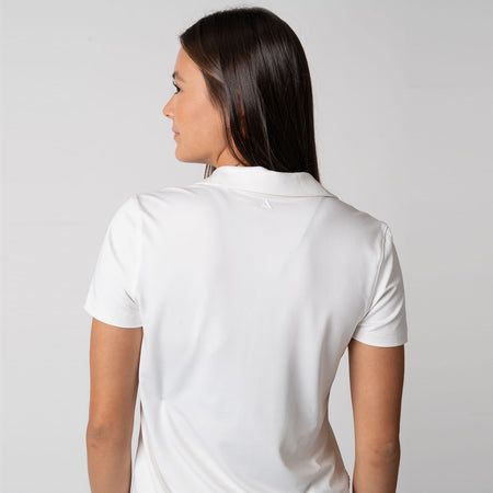 Image showing the back of a female model who is wearing a JOOLA women's club polo, white.