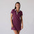 Image showing a female model wearing a JOOLA women's club polo dress, Bordeaux. 