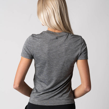 Image showing the back of female model who is wearing the JOOLA Women's Club Short Sleeve Shirt, Charcoal Heather.