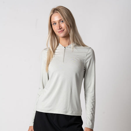 Female model wearing the JOOLA Women's Quarter Zip Pullover, Gravity Gray Heather.