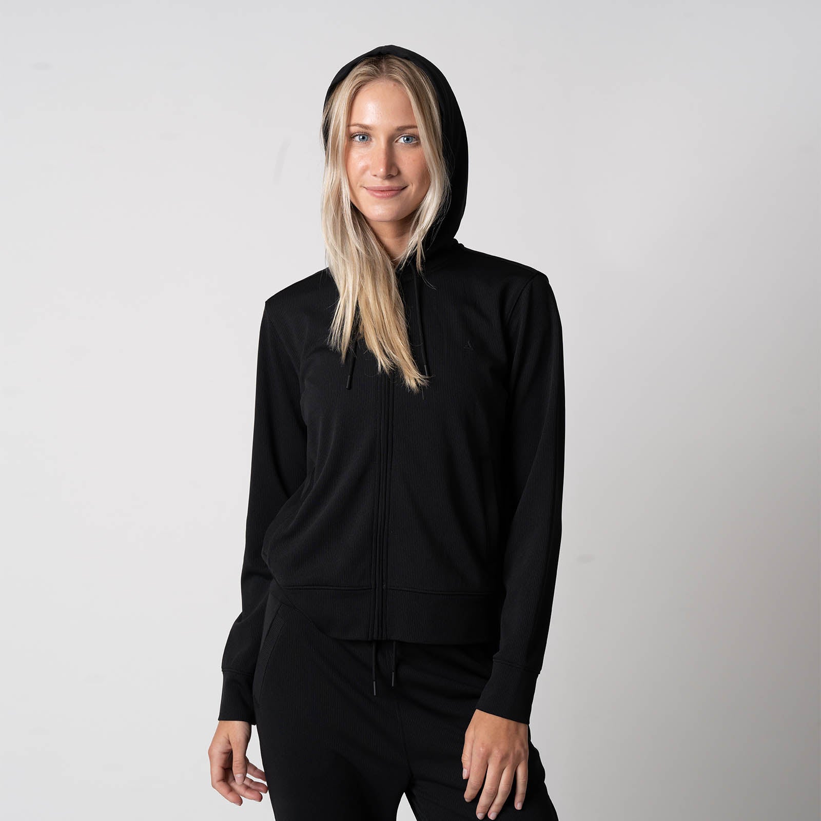 Image of a female model wearing a JOOLA Women's Ribbed Jacket, black.