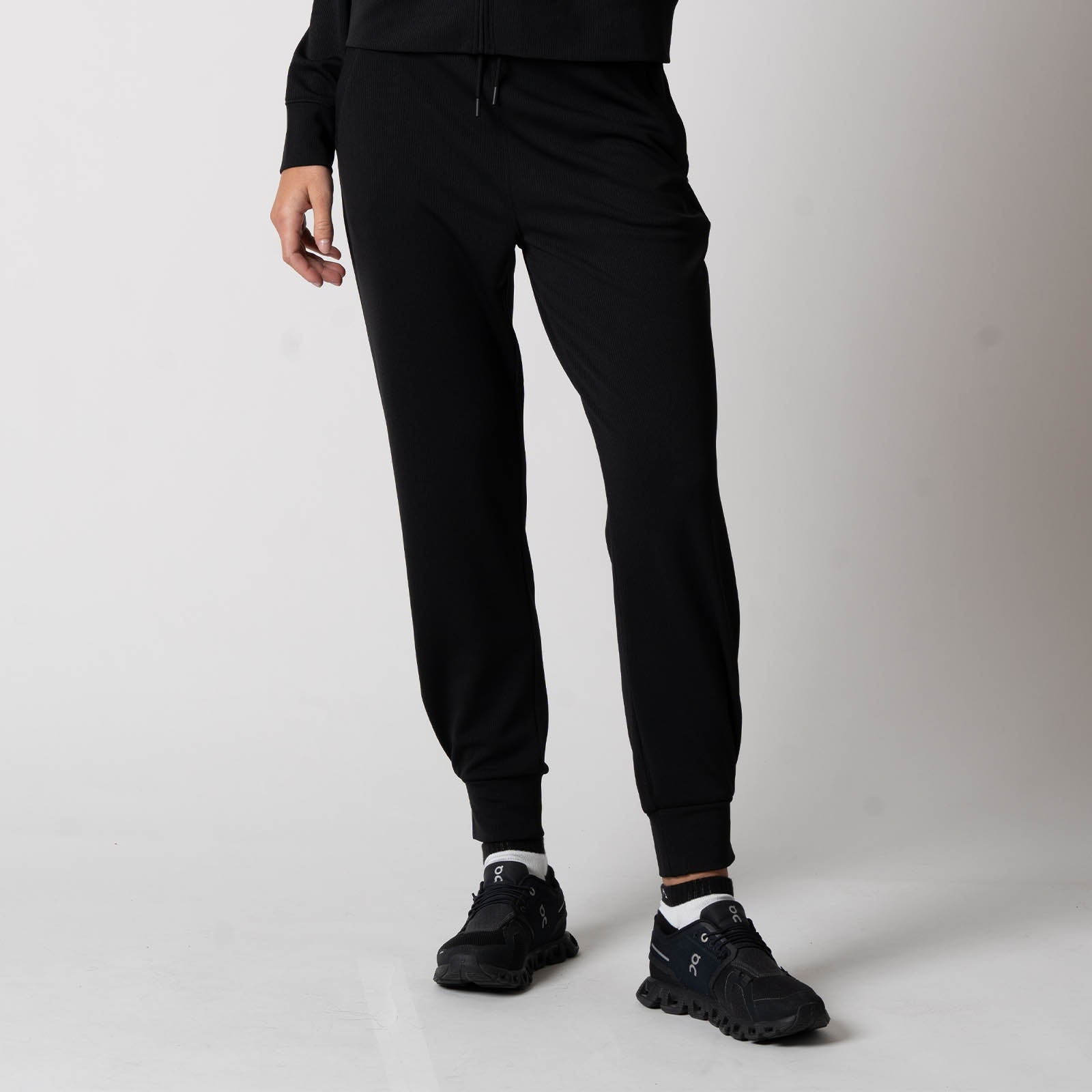 Image showing the legs of a female model who is modeling the JOOLA Women's Ribbed Jogger, Black.