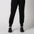 Image showing the lower half of a female models body, she is posing in a pair of JOOLA Women's Ribbed Joggers, black.