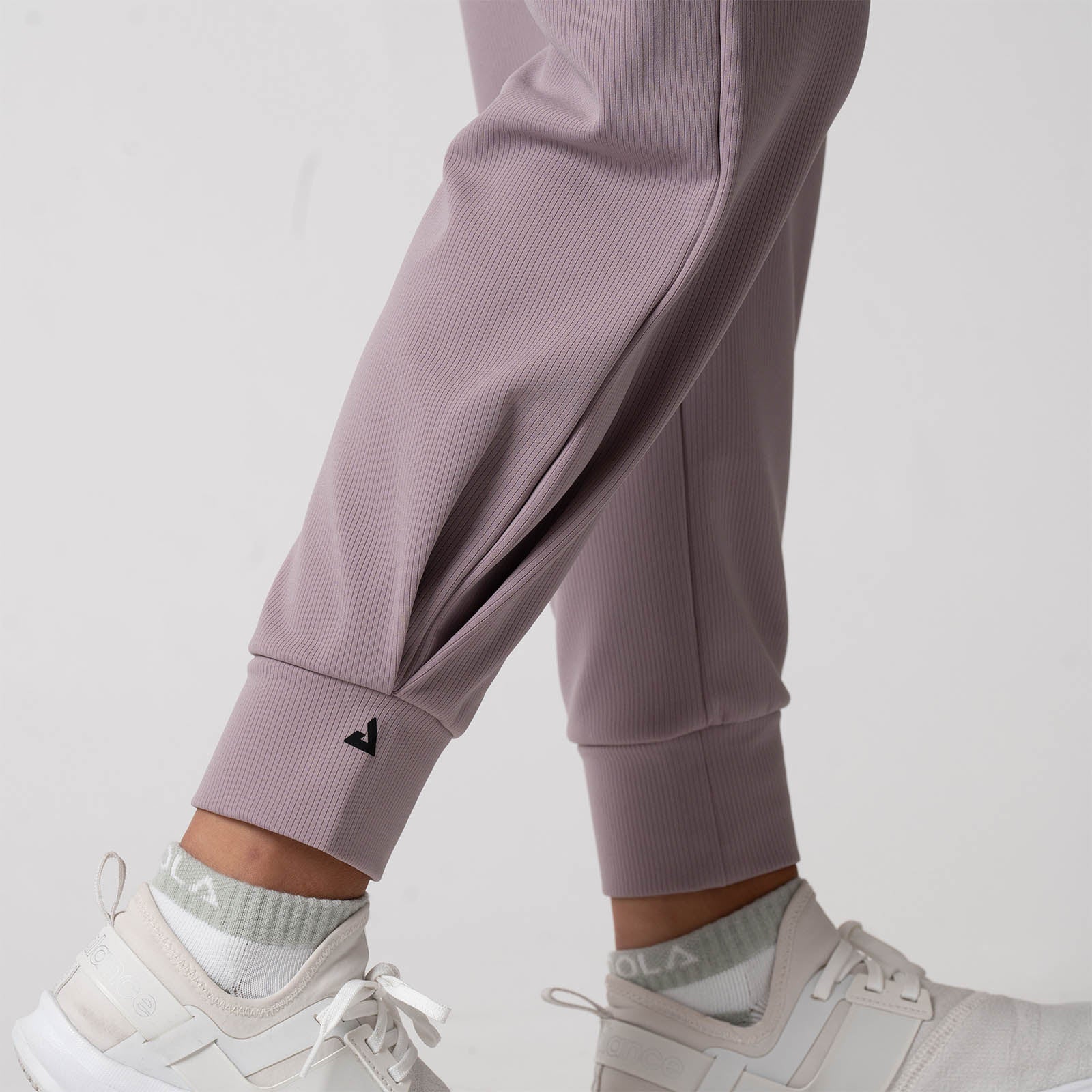 Close up image showing the JOOLA Trinity logo on the right cuff of the JOOLA Women's Ribbed Jogger, Dusty Mauve.