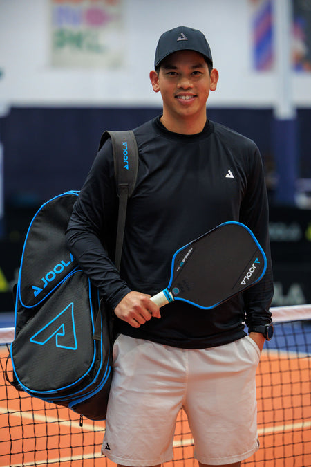 Close up image of JOOLA pro player with JOOLA 3S pickleball paddle in hand.