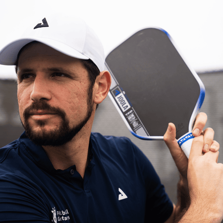 Image of JOOLA Pro Dekel Bar posing with his signature Dekel Bar Perseus Pro IV pickleball paddle in hand.
