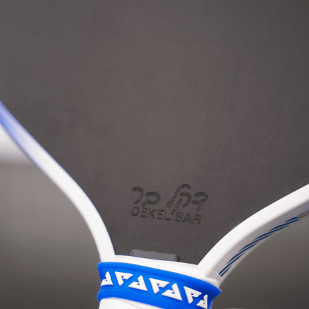 Close up image of the Hebrew lettering of Dekel Bar's name on the Dekel Bar Perseus Pro IV pickleball paddle.