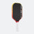 Pickleball paddle with black surface, red and yellow edges, and white handle on a white background