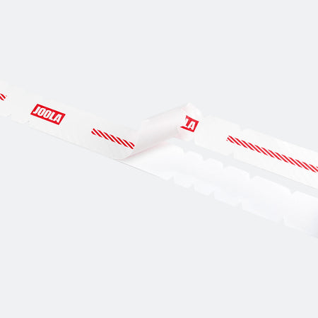 White background, close up image of an unrolled roll of JOOLA Pro IV edge guard tape.