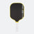 Pickleball paddle with black surface, yellow rim, and white handle on a white background