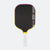 Pickleball paddle with black surface, yellow rim, and white handle on a white background.