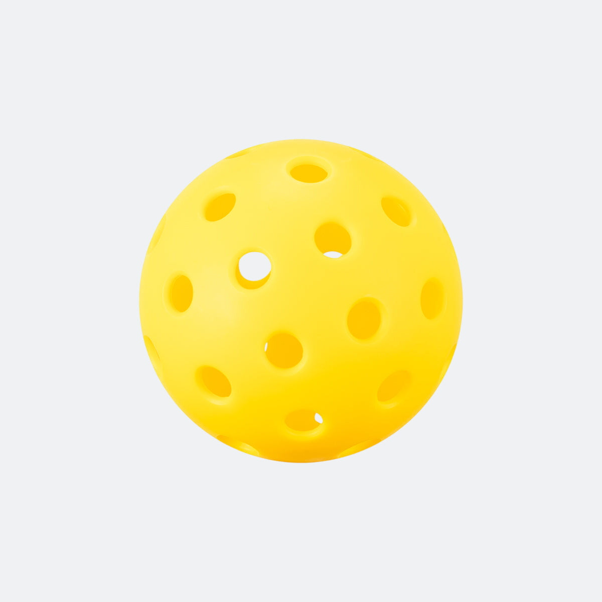 Yellow perforated pickleball on a white background.