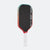 Pickleball paddle with black surface, red frame, and white handle on a white background