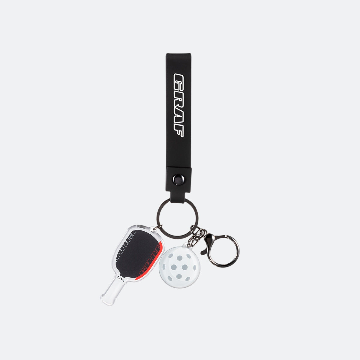 Graf keychain with paddle and white ball charm on a white background