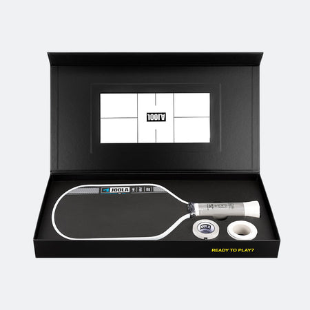 Pickleball paddle and ball set in a black box with a visible brand logo.