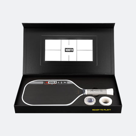 Pickleball paddle and ball set in a black box with a visible brand logo.
