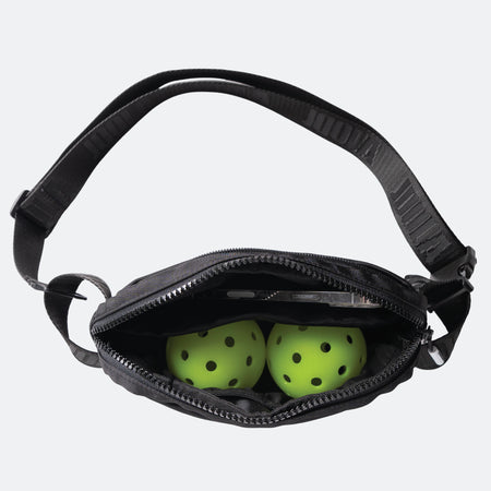 Aerial view of two-pickleballs inside a JOOLA belt bag.