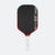 Pickleball paddle with black surface, red border, and white handle on a white background