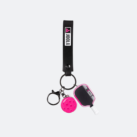 Magnus Pro IV keychain with paddle and ball charms on a white background