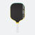 Pickleball paddle with black surface, yellow rim, and white handle on a white background.