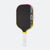 Pickleball paddle with black face, yellow rim, and white handle on a white background.