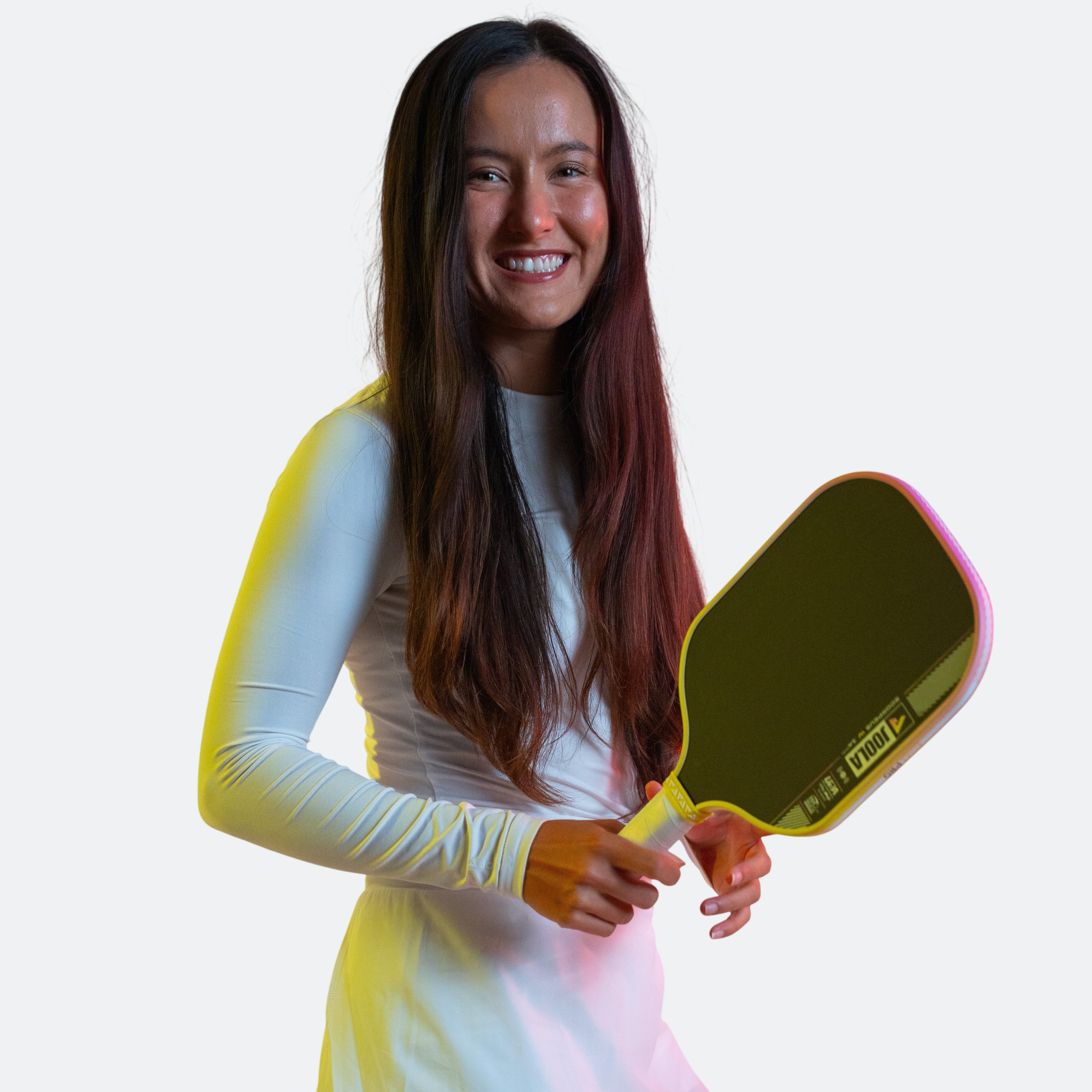Stylized pink and yellow background with JOOLA Pro Anna Bright holding a Scorpeus Pro IV in her hand.