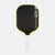 Pickleball paddle with black face, yellow rim, and white handle on a white background