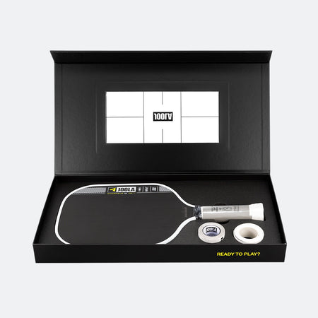 Pickleball paddle and ball set in a black box with a visible brand logo.