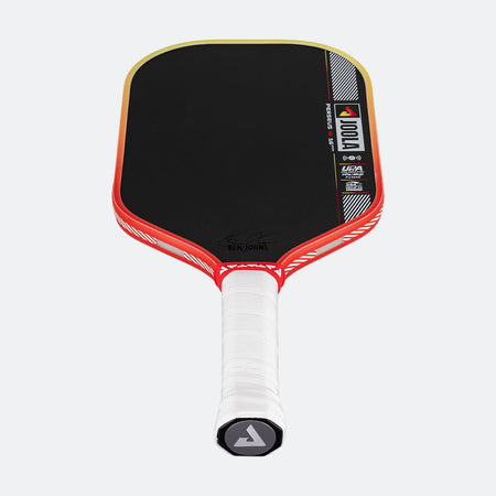 Pickleball paddle with black face, red frame, and white handle on a white background