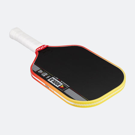 Pickleball paddle with black surface, red border, and yellow rim on a white background