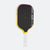 Pickleball paddle with black face, yellow sides, and white handle on a white background.