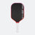 Pickleball paddle with black surface, red edges, and white handle on a white background