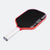 Pickleball paddle with red frame and black surface on a white background