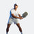 Ben Johns holding a pickleball paddle in his hand posing in front of a white backdrop.