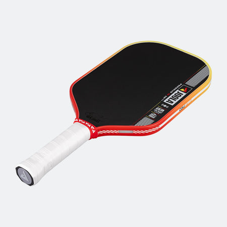 Pickleball paddle with black playing surface, red frame, and white handle on a white background