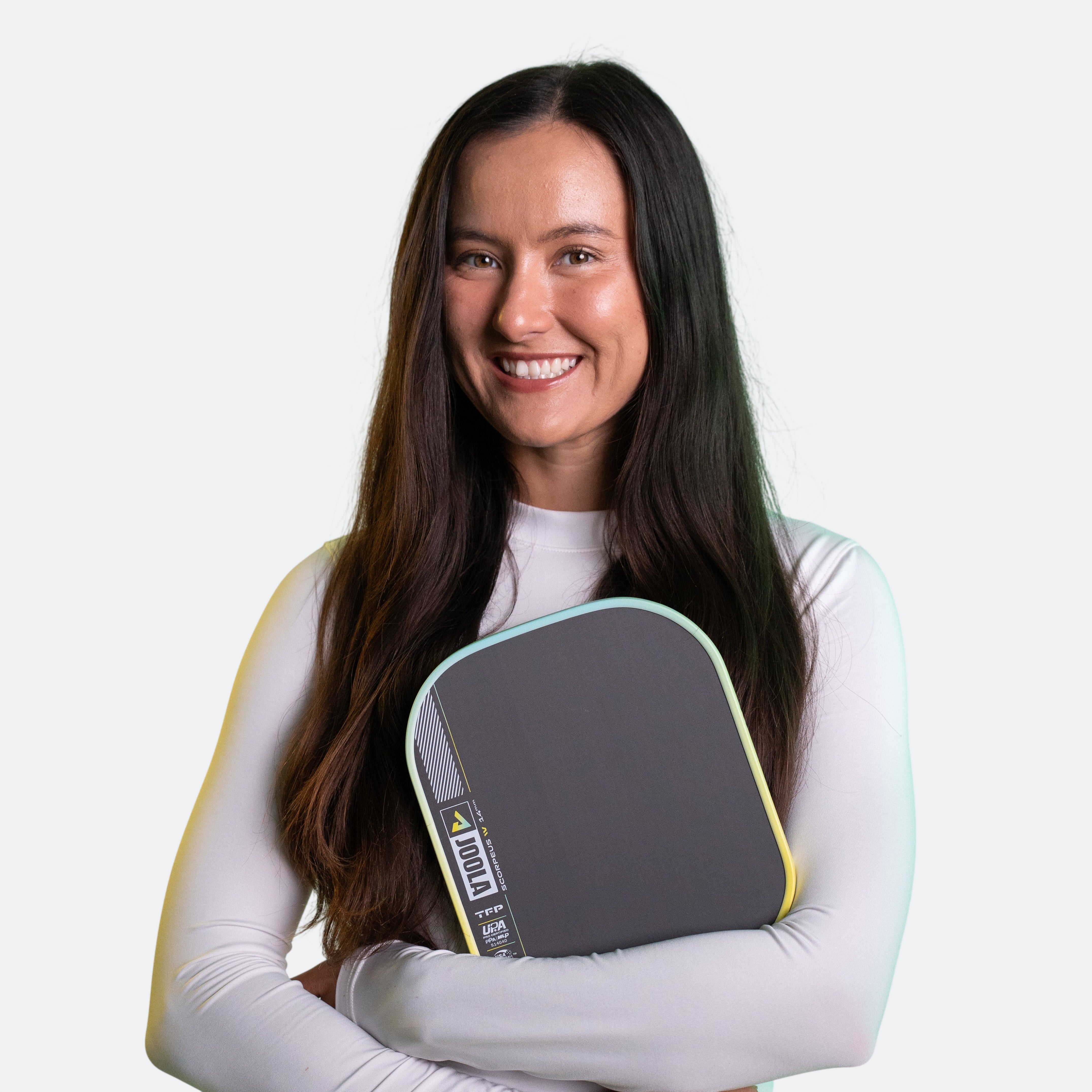 Yellow and green background, image of JOOLA Pro Anna Bright clutching a Scorpeus Pro IV in her hands.