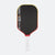 Pickleball paddle with black surface, red border, and white handle on a white background