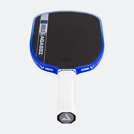White background, product image showing the JOOLA Agassi Pro V pickleball paddle with blue edge guard and white handle.