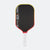 Pickleball paddle with black face, red border, and white handle on a white background